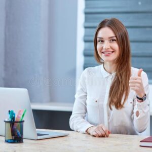 girl-office-worker-sitting-headphones-smiling-showing-thumb-up-happy-young-desk-laptop-wearing-gesture-106665747